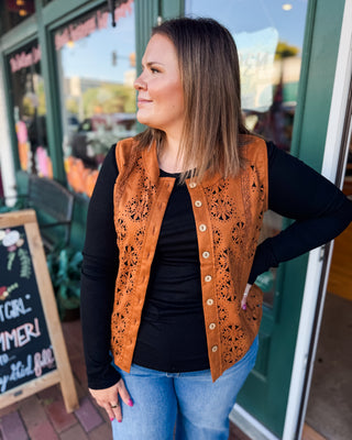 a sleeveless suede laser cutout button down vest in a cognac color.