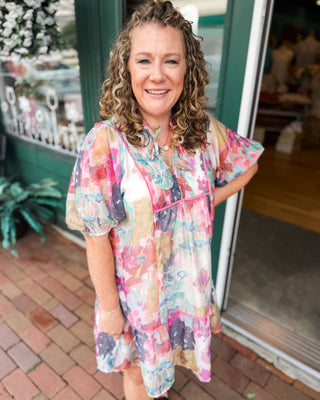 a watercolor baby doll mini dress with pink piping