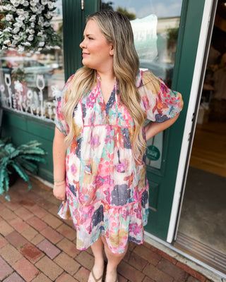 a watercolor mini knee length dress with pink piping
