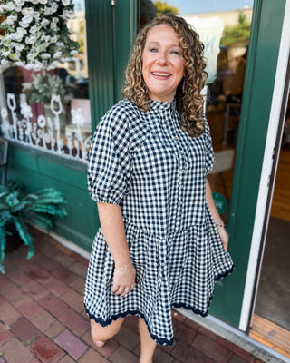 Gingham & Gatherings Ric Rac Trim Dress. A drop hem button front dress in a navy.